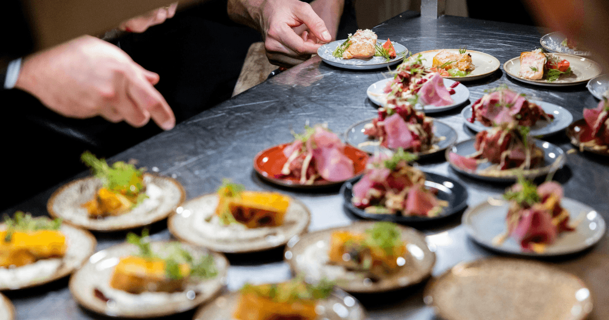 Hands plating a retreat dish — chef directory hero