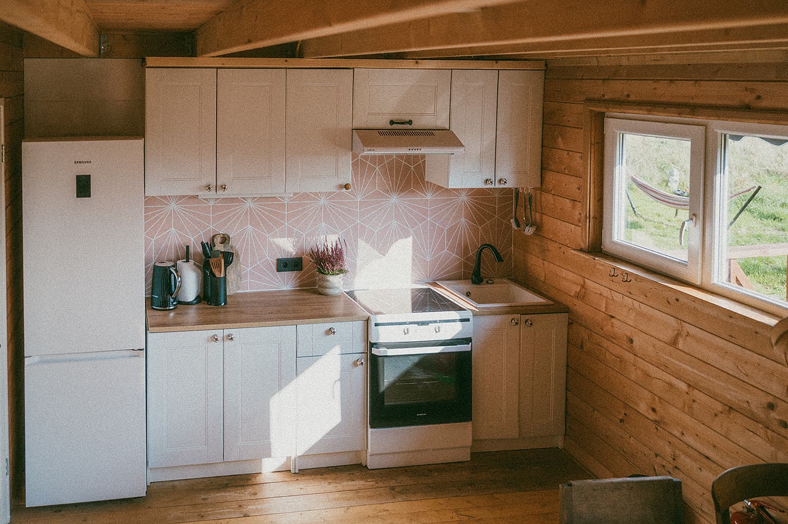 Kitchen in the Cosmos wooden cabin with wood stove