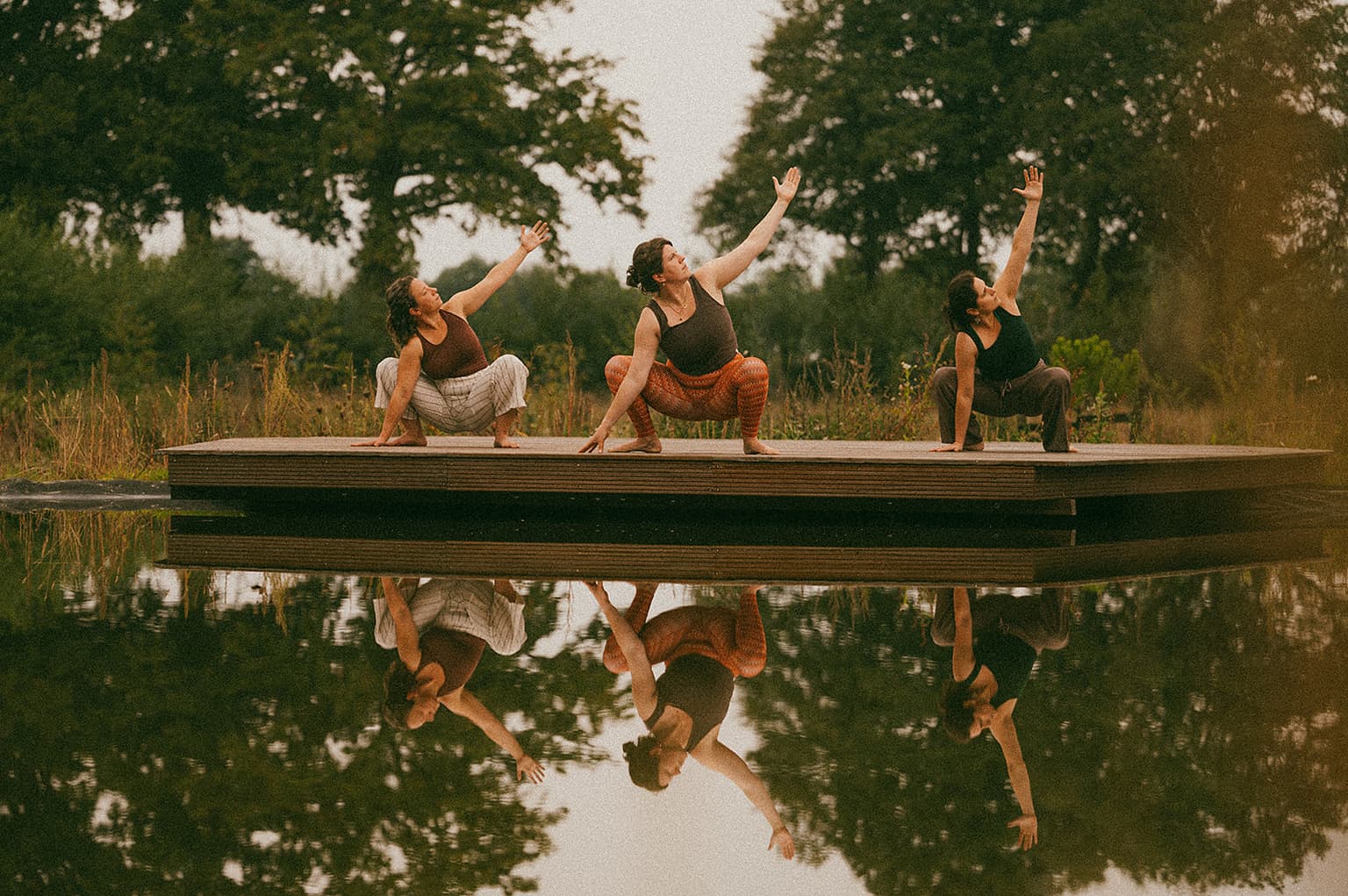 Yoga session at the pond jetty with reflection