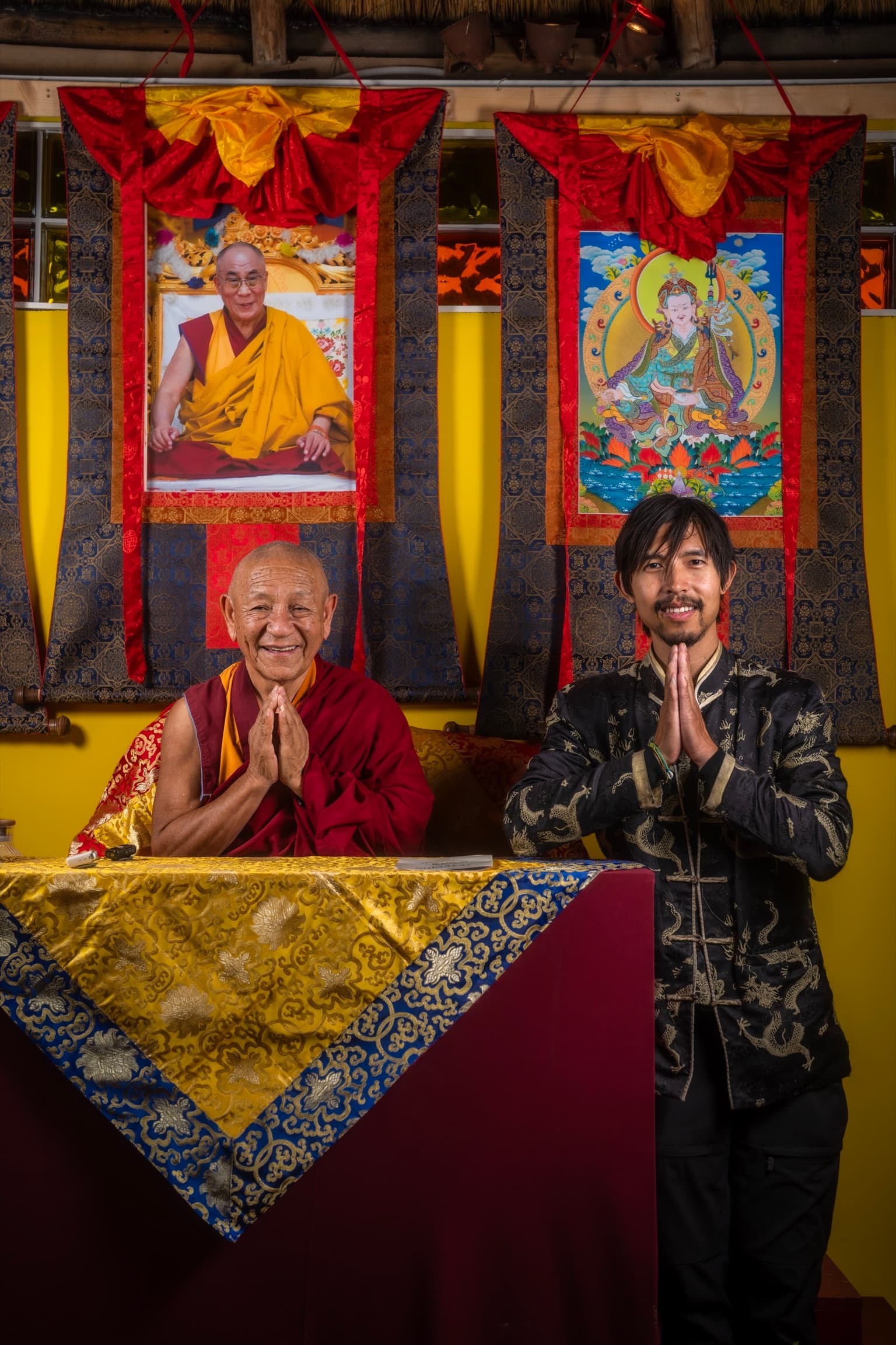 Gen La Geshe Pema Dorjee and monk Lobsang greeting the room